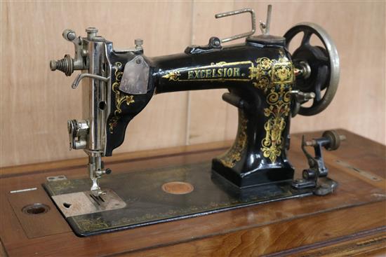 An Excelsior sewing machine within table W.95cm